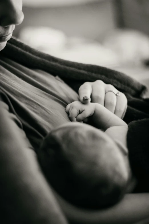 a woman is holding a baby in her arms