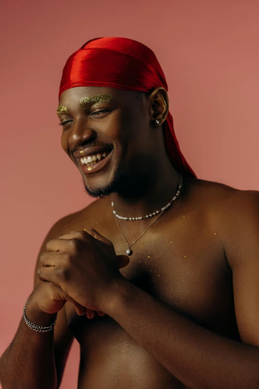 a black man in a red bandana smiles for the camera