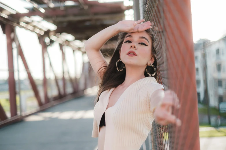 a girl posing for a picture near the train tracks