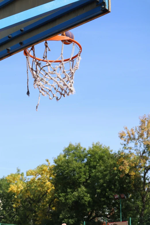 a man dunking a basketball in a hoop