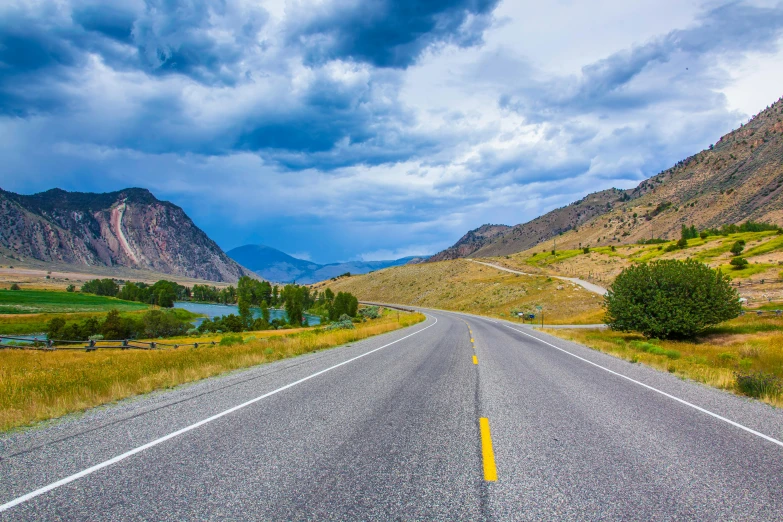 the road near the mountains is empty during the day