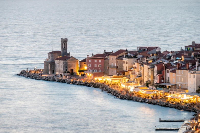 a small town is lit up by a harbor