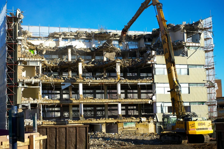 a crane is working on the side of a building under construction