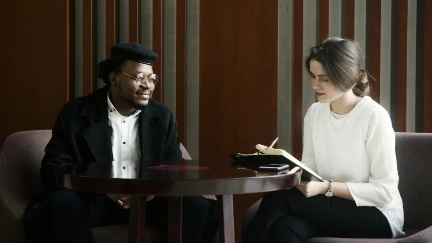 a man and a woman sitting in a room together