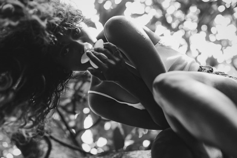 a black and white po of a woman holding flowers