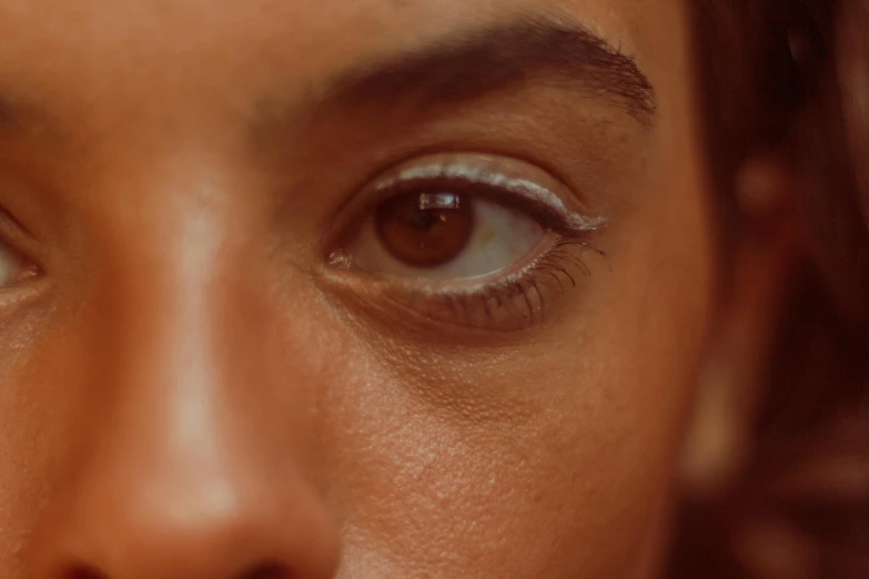 an extreme close up view of a woman's blue eyes