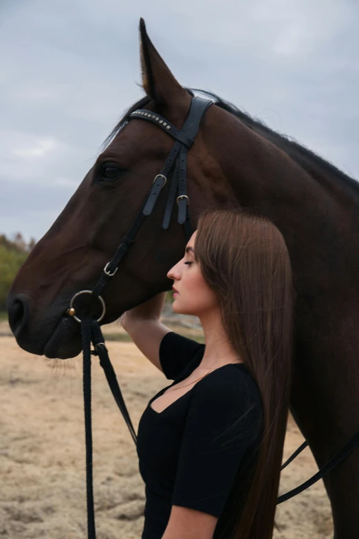 a woman with long hair and a horse