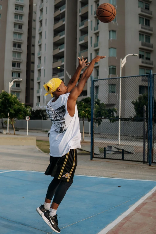 a basketball player dunks a ball on the court