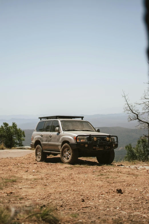 a silver pickup truck with a roof rack on the back