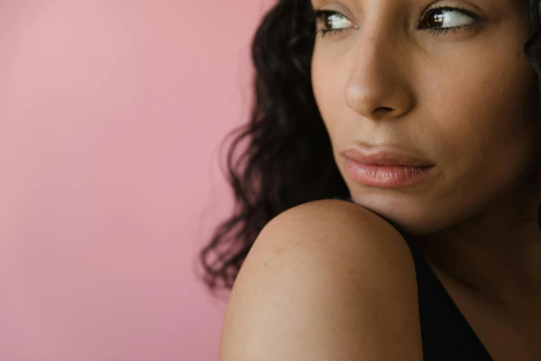 the woman has a beautiful expression and is wearing a black top