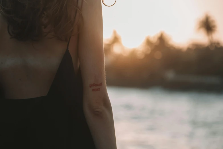 a woman with earrings is looking at the water