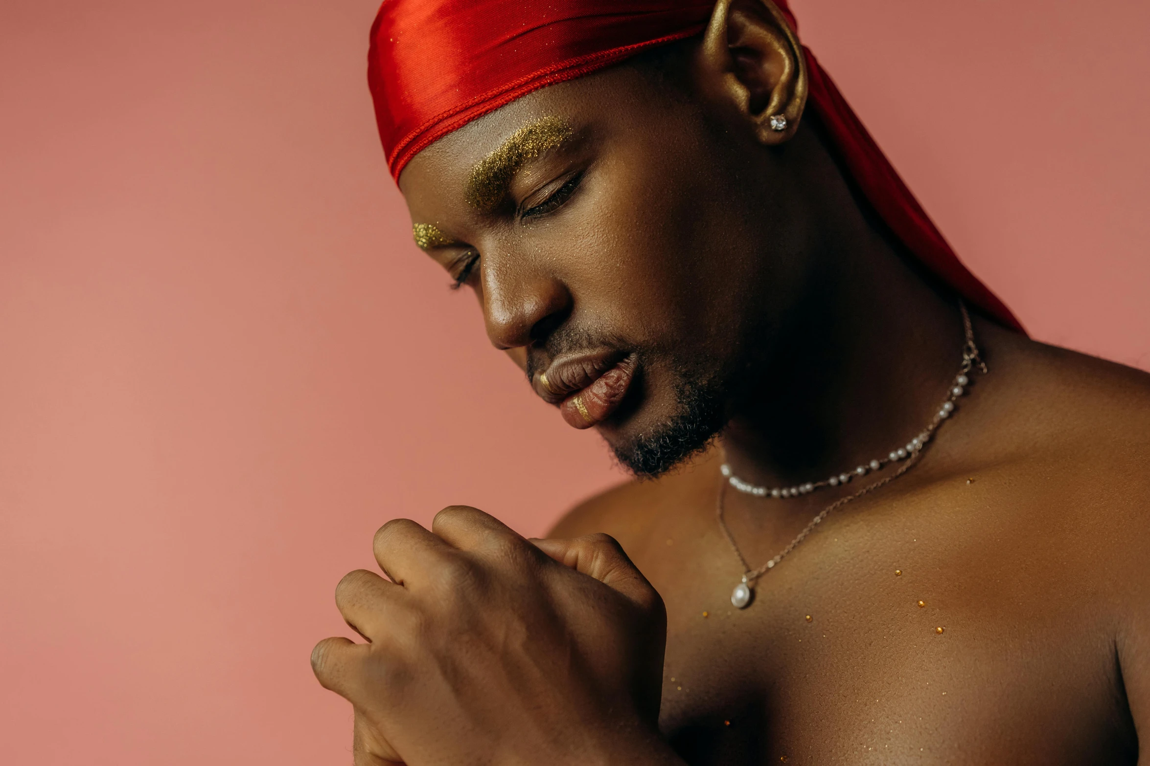 black man with gold paint on his body and head