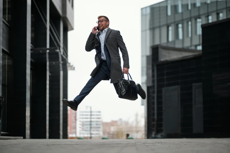 a man in business attire running on the phone