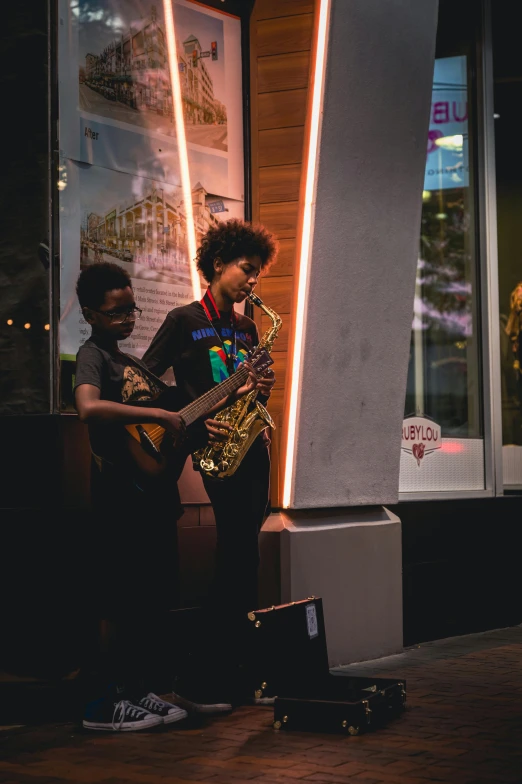 two people playing outside a building at night