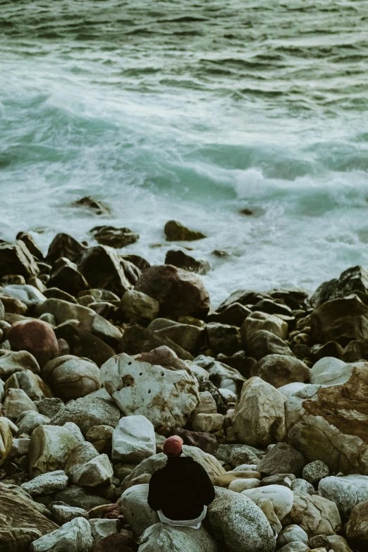 a black and white po of rocks near water