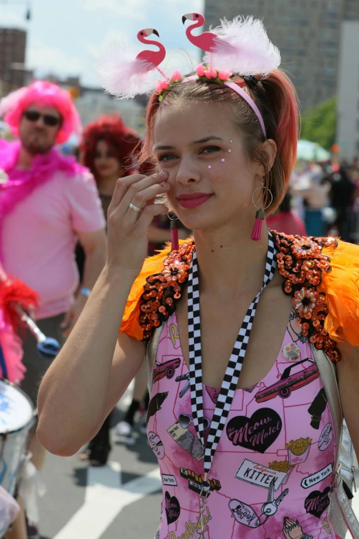 a women wearing pink and orange in a parade