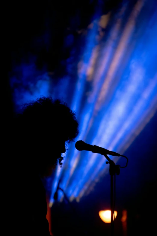 a person playing the guitar on stage at night