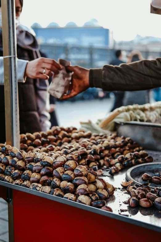 a man preparing dates at a fruit stand