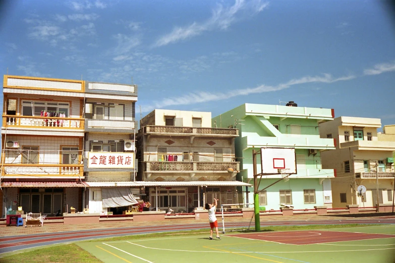 there is a man playing tennis on the street