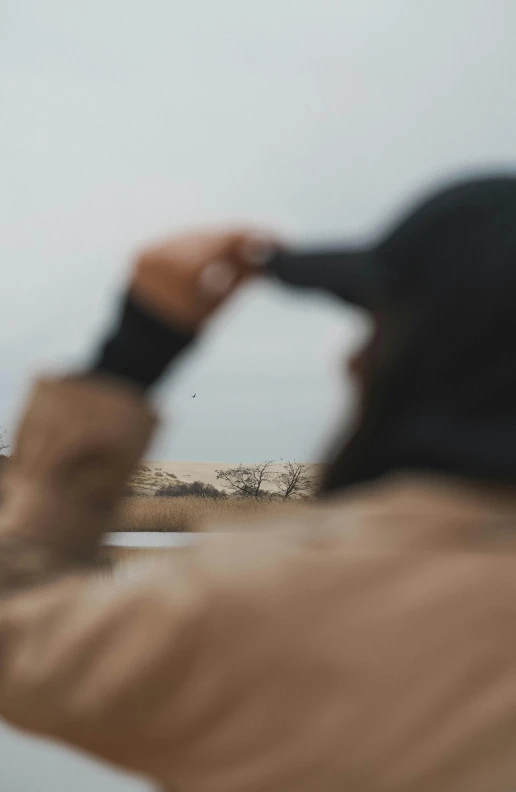 a man is holding his hand out as he looks at a boat