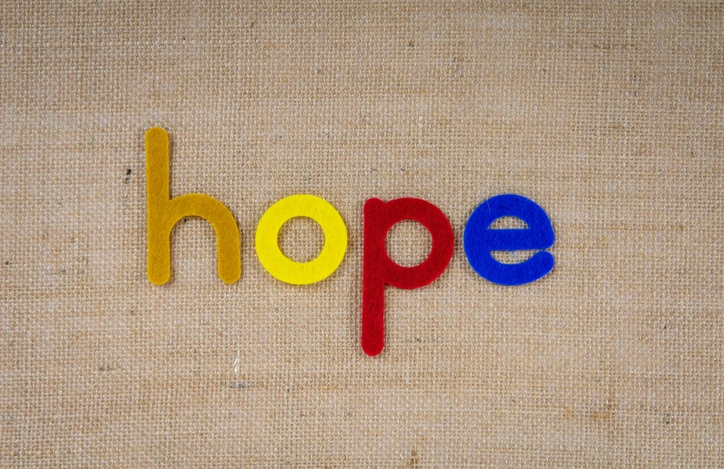 the word hope carved into a canvas