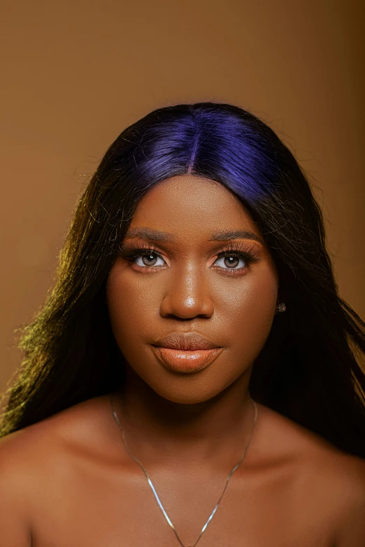 a young woman has purple hair and orange eyes