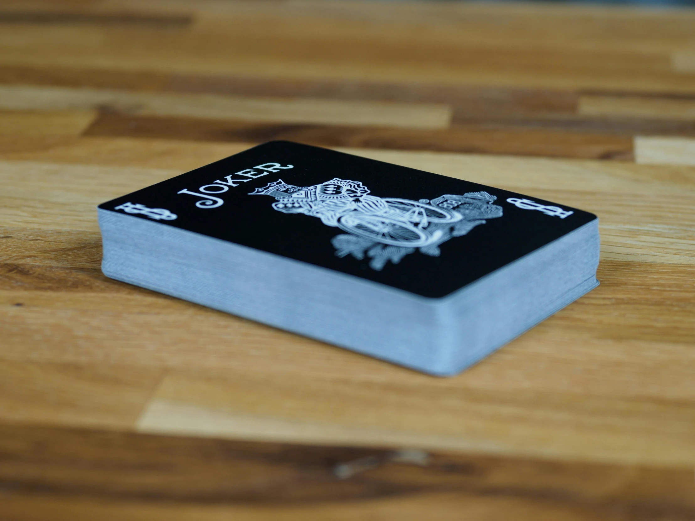 a small black and silver box sitting on a wooden table