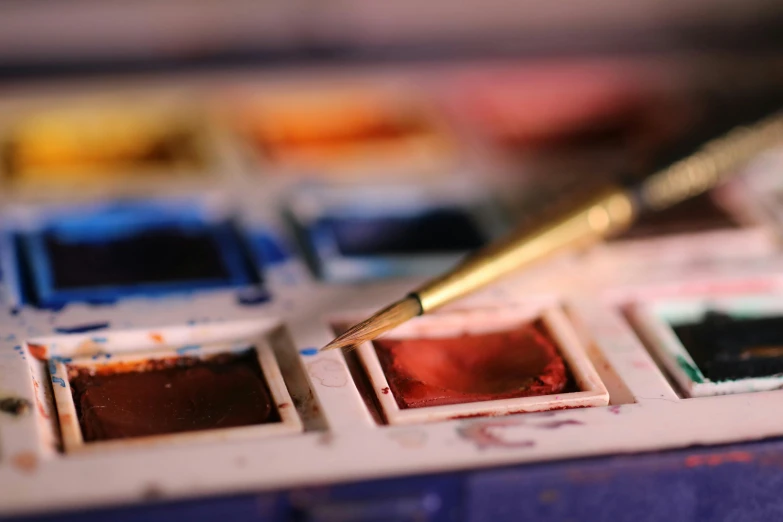 different squares of colorful art paint sitting on top of a table