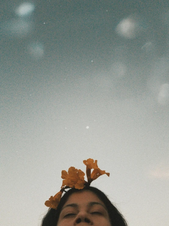 a woman looking at soing while wearing a head piece