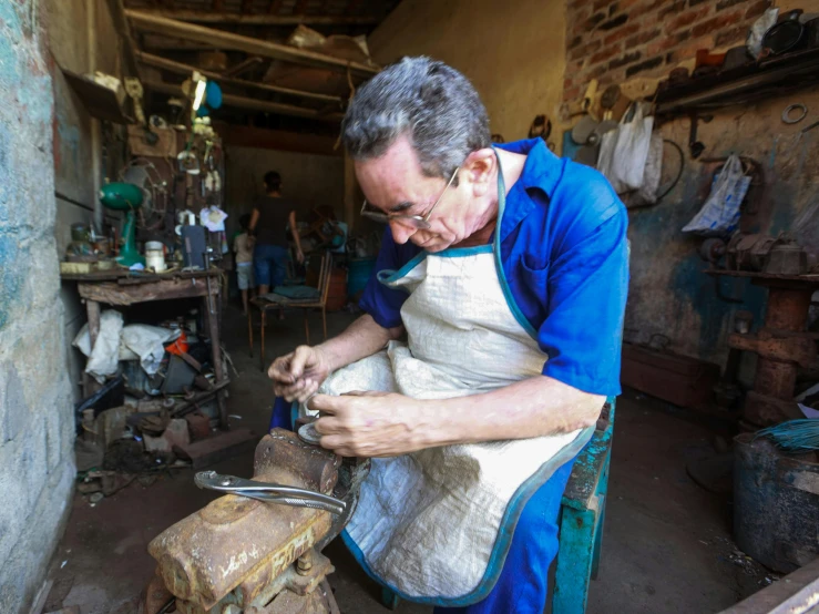 a man is working on an object in his room