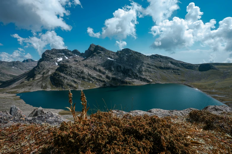 a lake on the edge of a mountain