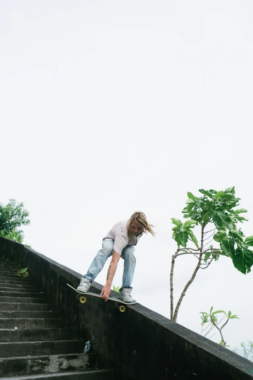 a person riding a skateboard on top of a stair rail