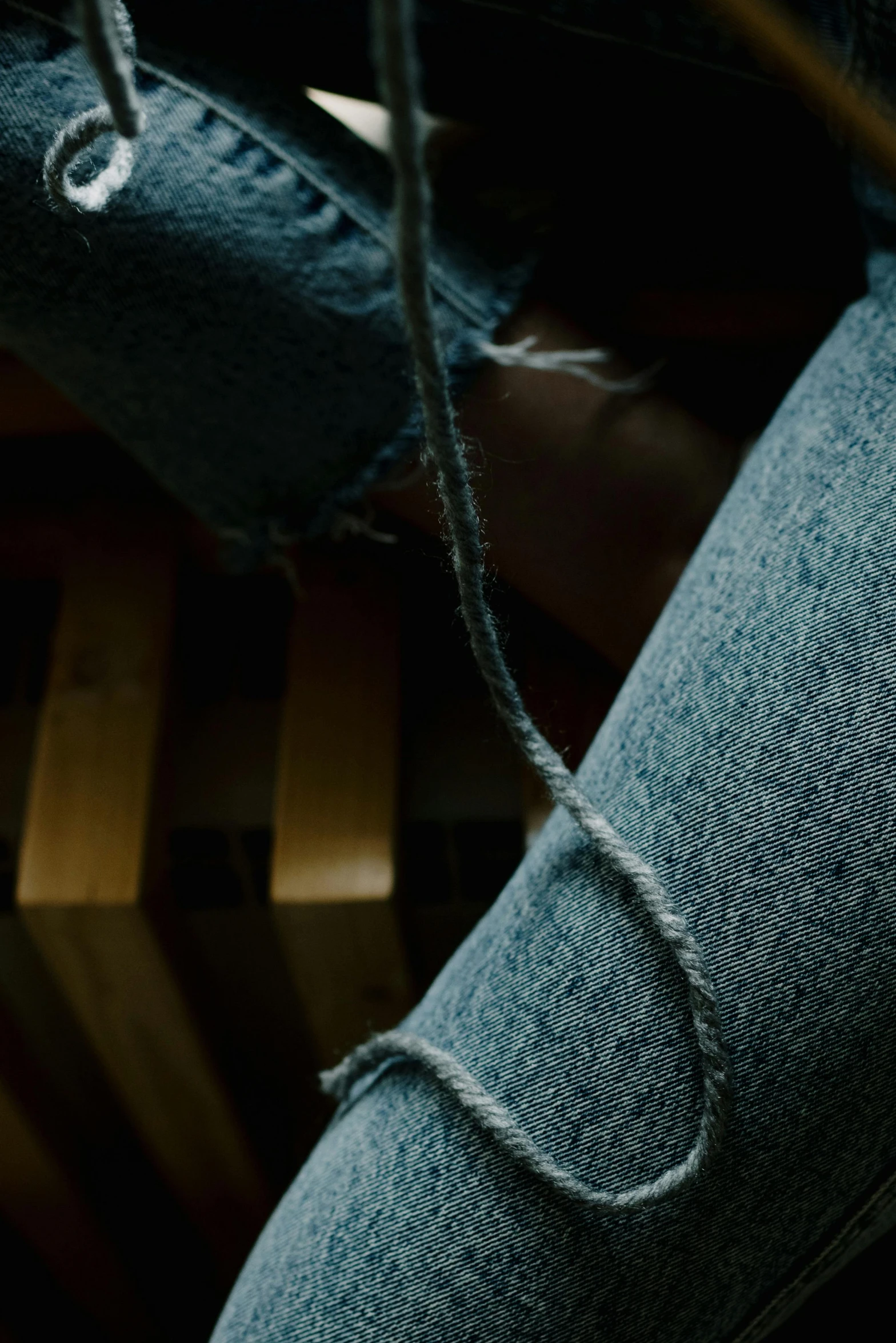 an empty wooden chair with a string on it