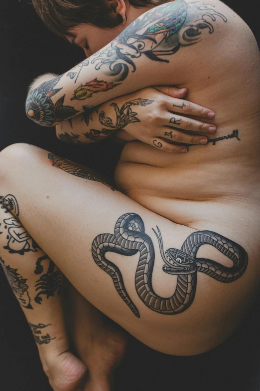 woman with tattoo arms holding on to arm