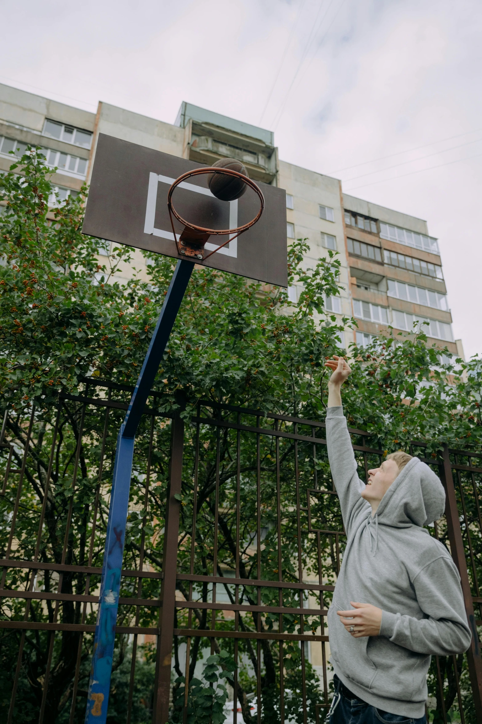 a man is shooting the basketball into the net