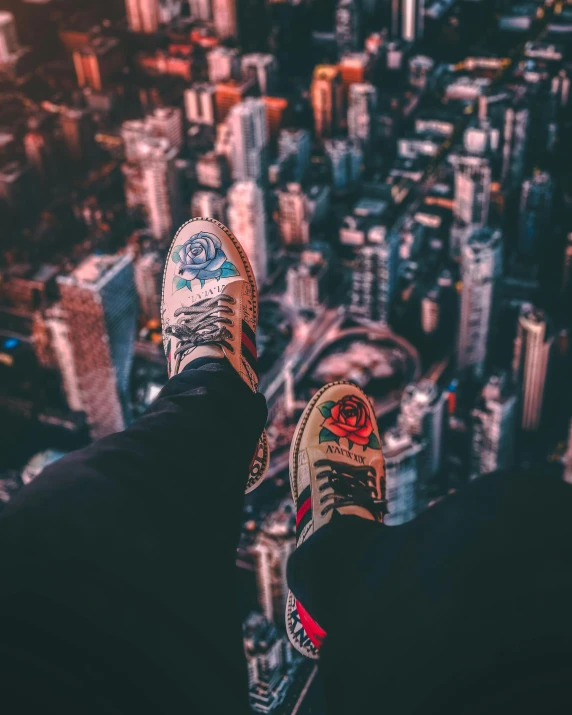 a person's feet are standing on the edge of a skyscr