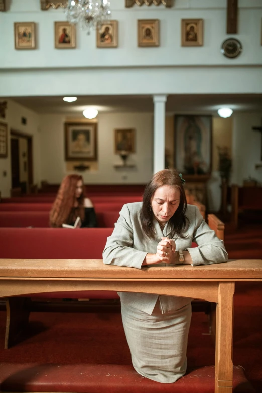 a woman sitting at the end of a wooden bench