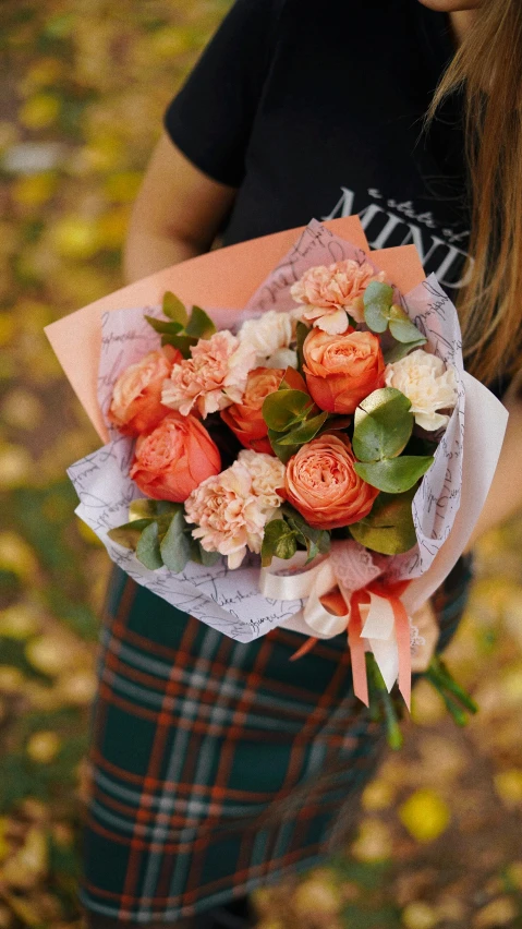 the  is holding the bouquet of flowers