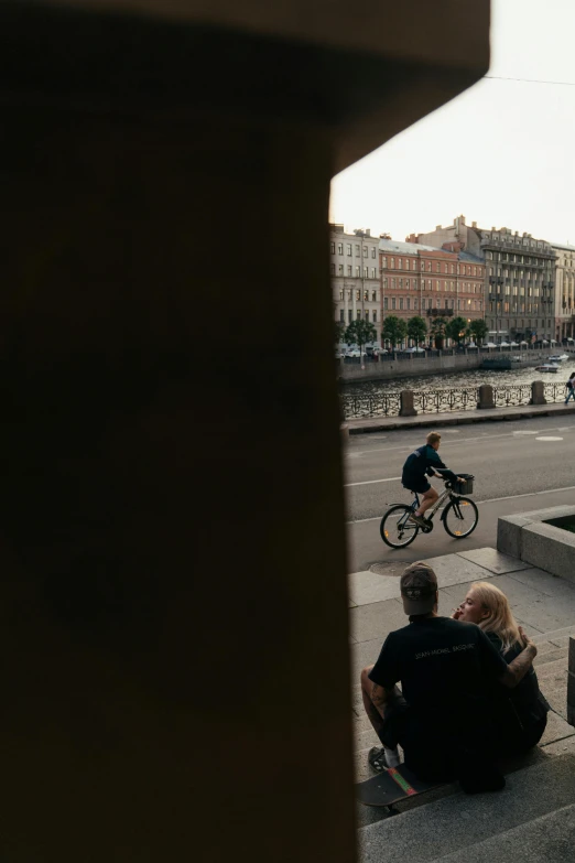 people sit on the curb of a concrete bench