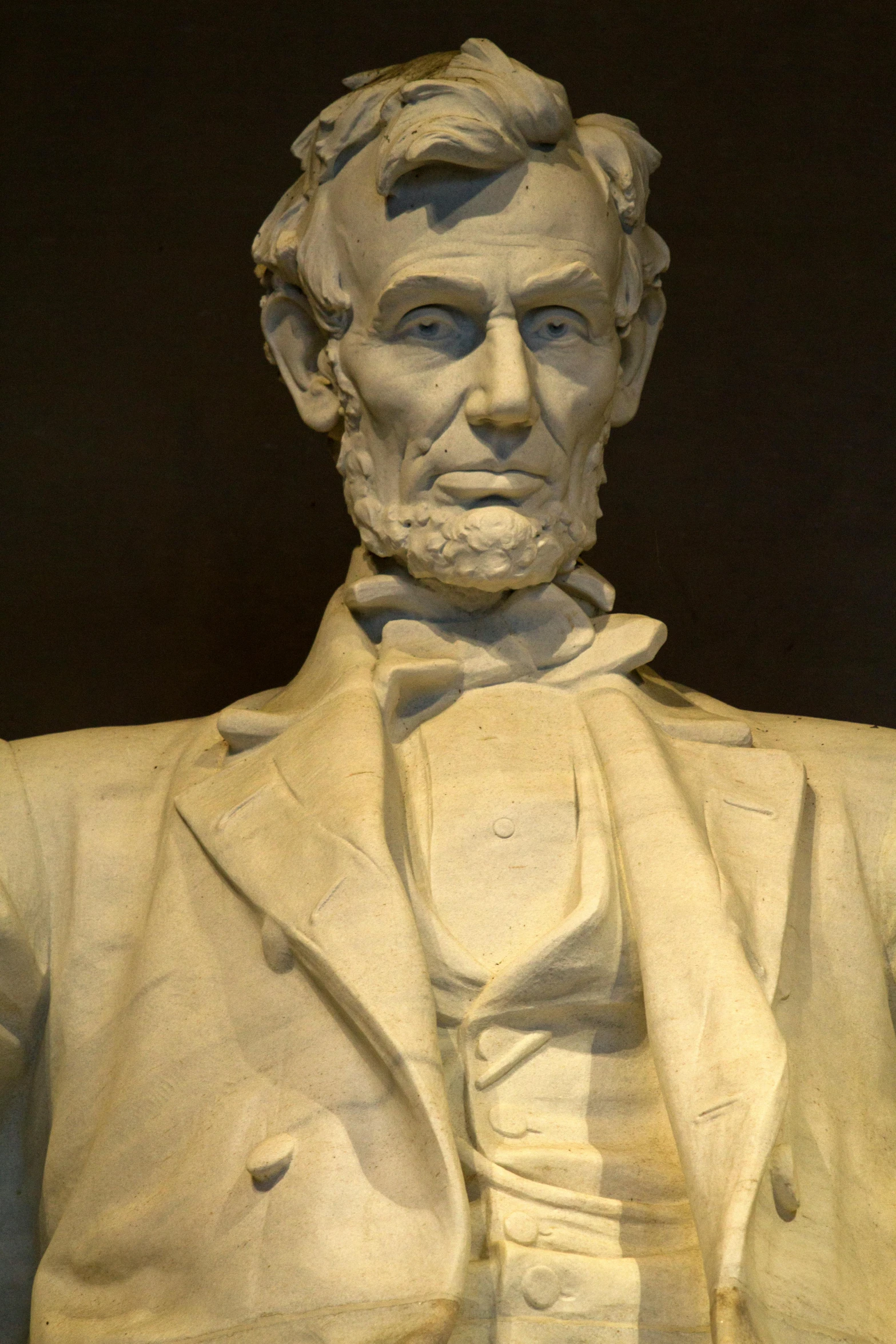 a sculpture of aham lincoln holding his coat down