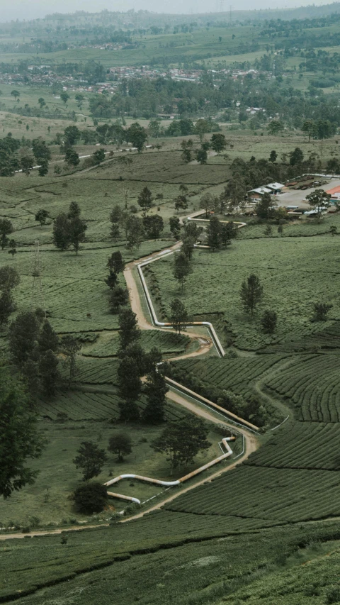 a scenic view of the countryside with green rolling hills and trees