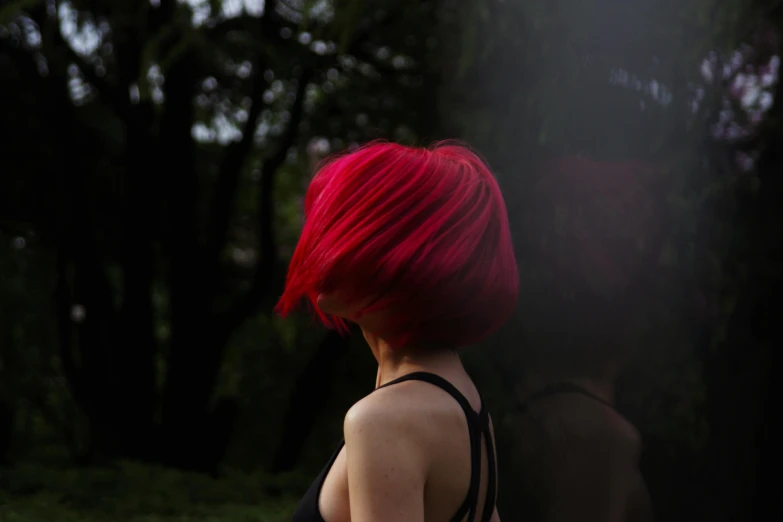 the back of a woman with red hair, looking over her shoulder