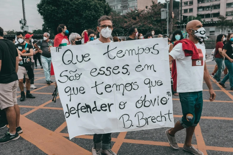 a man walking with a sign attached to his face