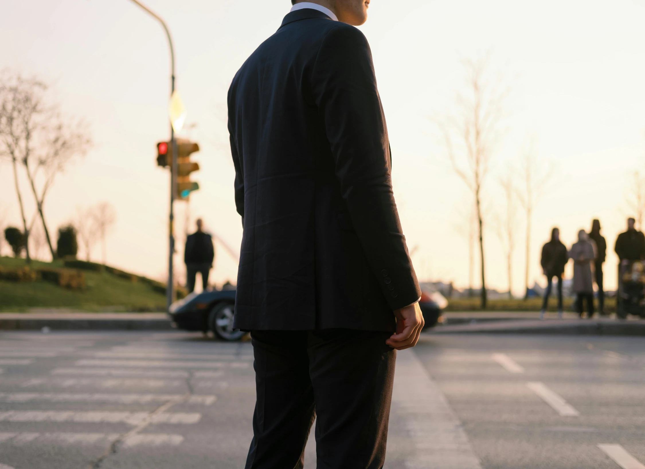 an image of a man in suit and tie at a street corner