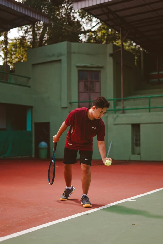 a young man is getting ready to serve the ball