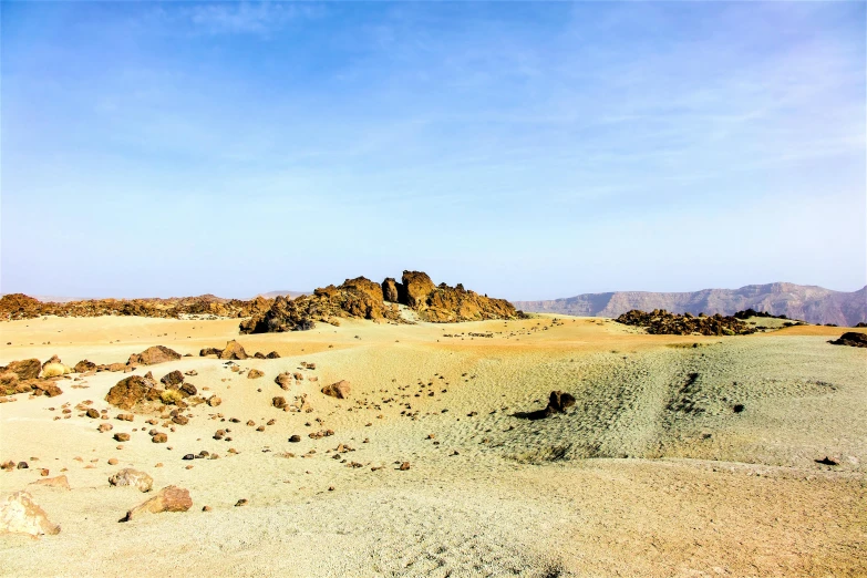 rocks and sand are on the ground in the desert