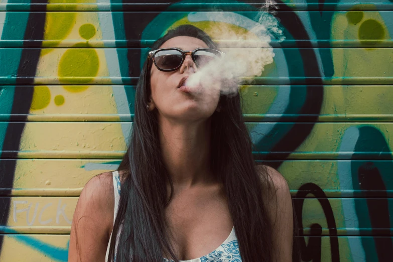 a woman standing with her smoke coming from her mouth