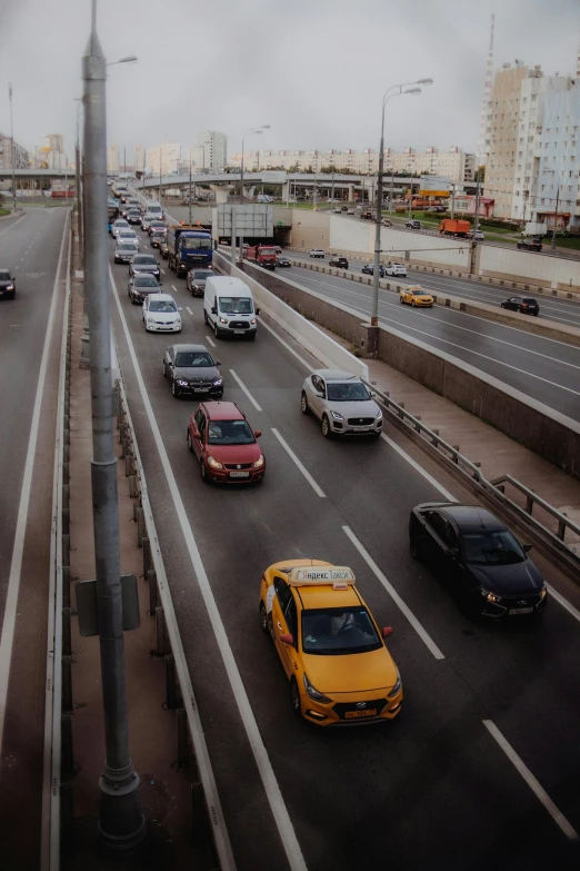 a bunch of cars are traveling down a busy street