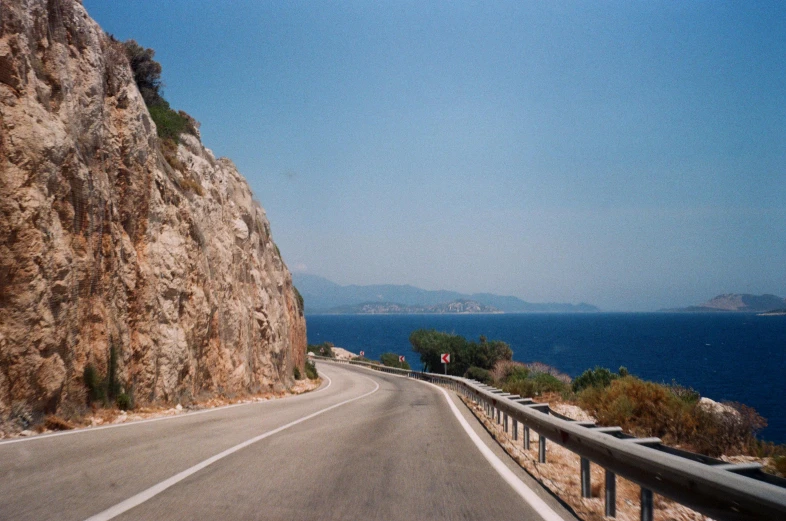 two people are standing near the side of the road