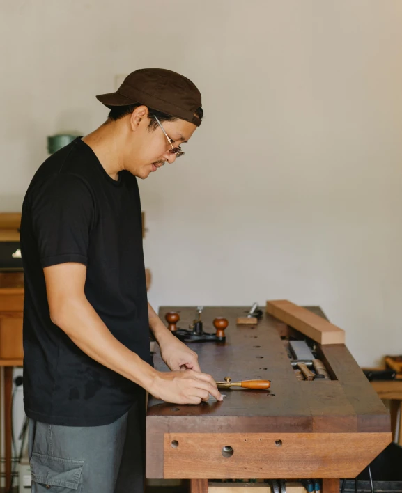 a man making soing with some kind of tool